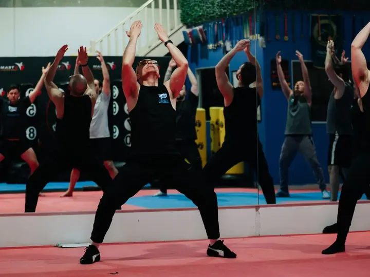 Adults training self-defence in a martial arts class